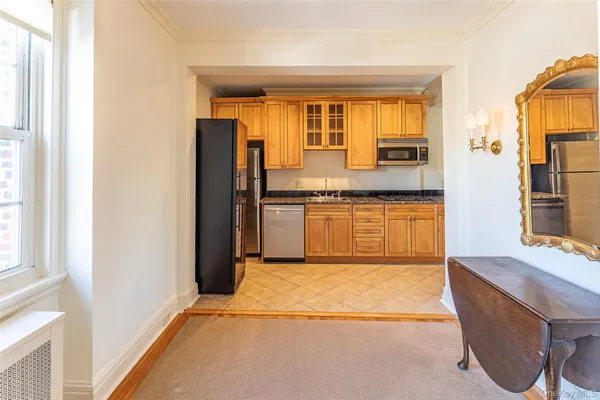 a view of a kitchen with wooden floor and a window