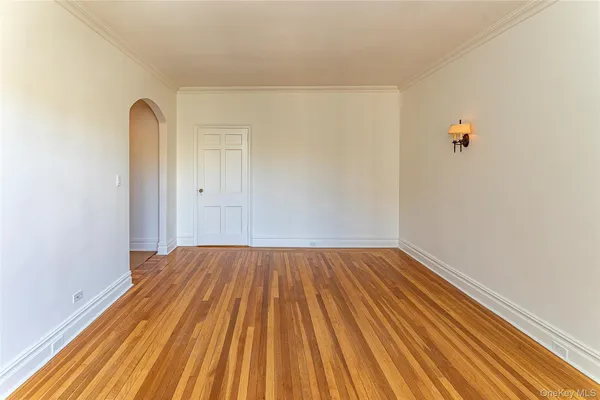 a view of a room with wooden floor and white walls