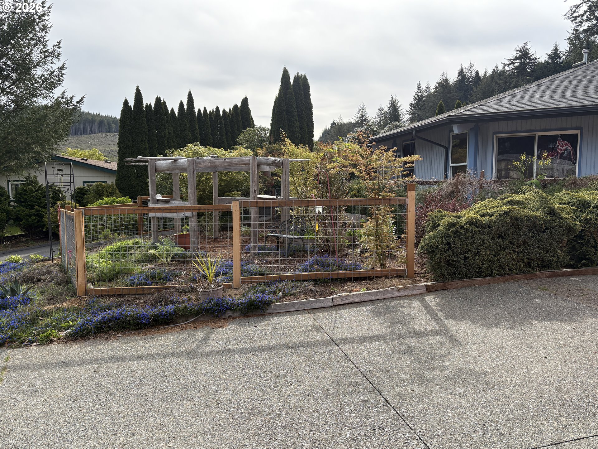 1625 Kristi Loop Lakeside, OR 97449 - Photo 8 of 41 a view of a house with a garden