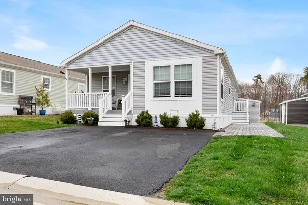 a front view of a house with a yard and porch