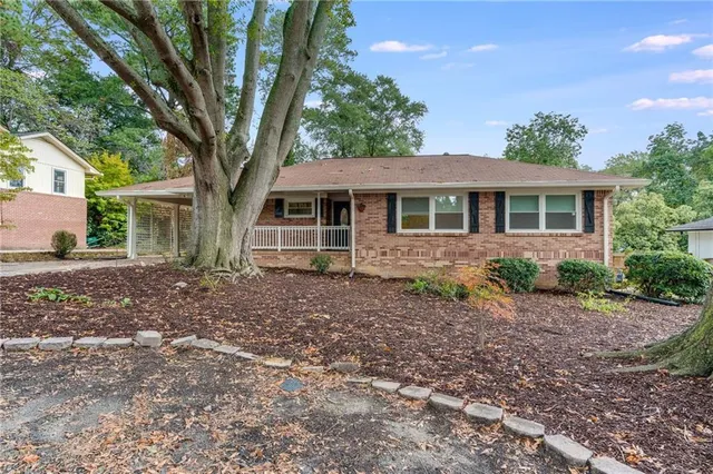 a house that has a tree in front of it