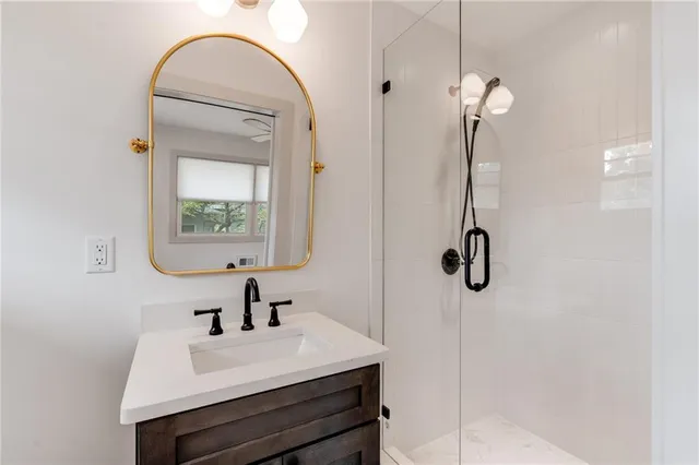 a bathroom with a sink a mirror and shower