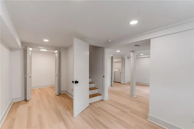 a view of a big room with wooden floor and windows