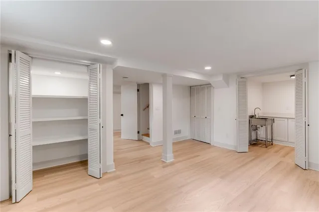 a view of an empty room with a kitchen
