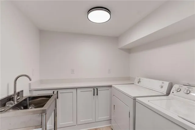 a view of a storage and utility room with washer and dryer