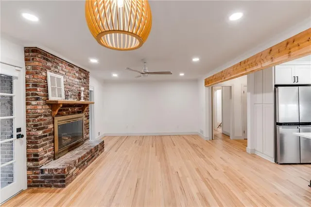 a kitchen with granite countertop stainless steel appliances a stove top oven and a refrigerator