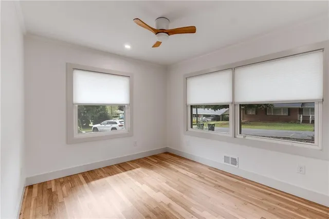 an empty room with a empty space and windows