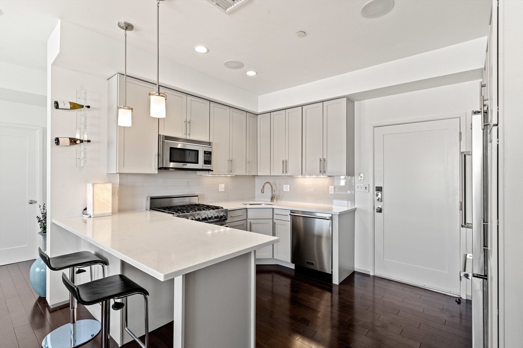 345 D Street, Unit 11 Boston, MA 02127 - Photo 1 of 23 a kitchen with a stove a sink and a refrigerator