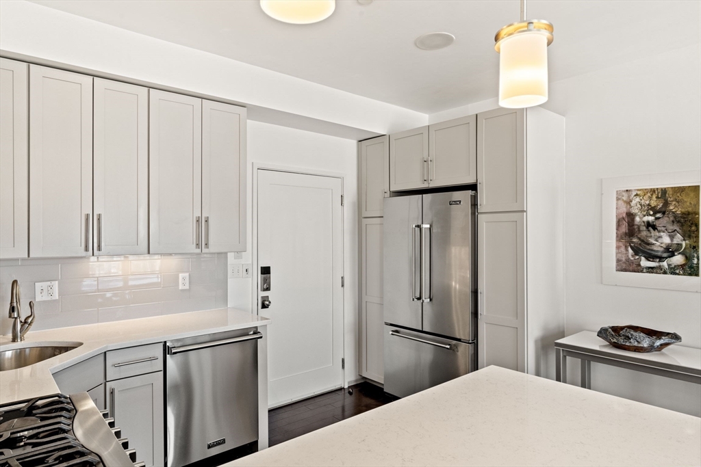 345 D Street, Unit 11 Boston, MA 02127 - Photo 11 of 23 a kitchen with stainless steel appliances a refrigerator sink and cabinets