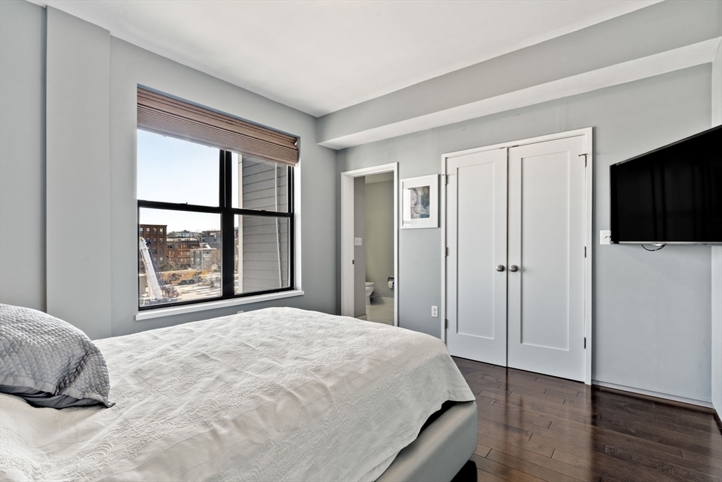 345 D Street, Unit 11 Boston, MA 02127 - Photo 13 of 23 a bedroom with a bed and a large window