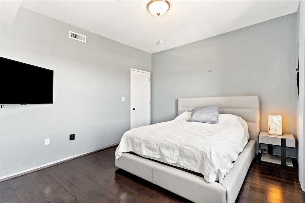 345 D Street, Unit 11 Boston, MA 02127 - Photo 14 of 23 a bedroom with a bed and a flat screen tv