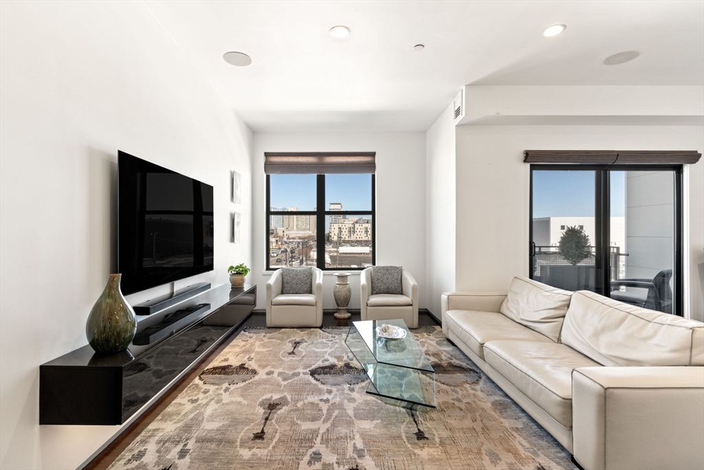 345 D Street, Unit 11 Boston, MA 02127 - Photo 2 of 23 a living room with furniture and a flat screen tv