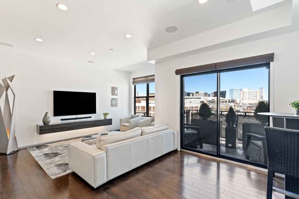 345 D Street, Unit 11 Boston, MA 02127 - Photo 3 of 23 a living room with furniture and a flat screen tv