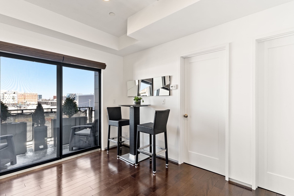345 D Street, Unit 11 Boston, MA 02127 - Photo 7 of 23 a view of a dining room with furniture and wooden floor