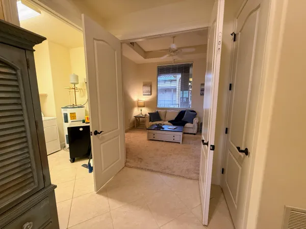 a bedroom with a bed and a refrigerator