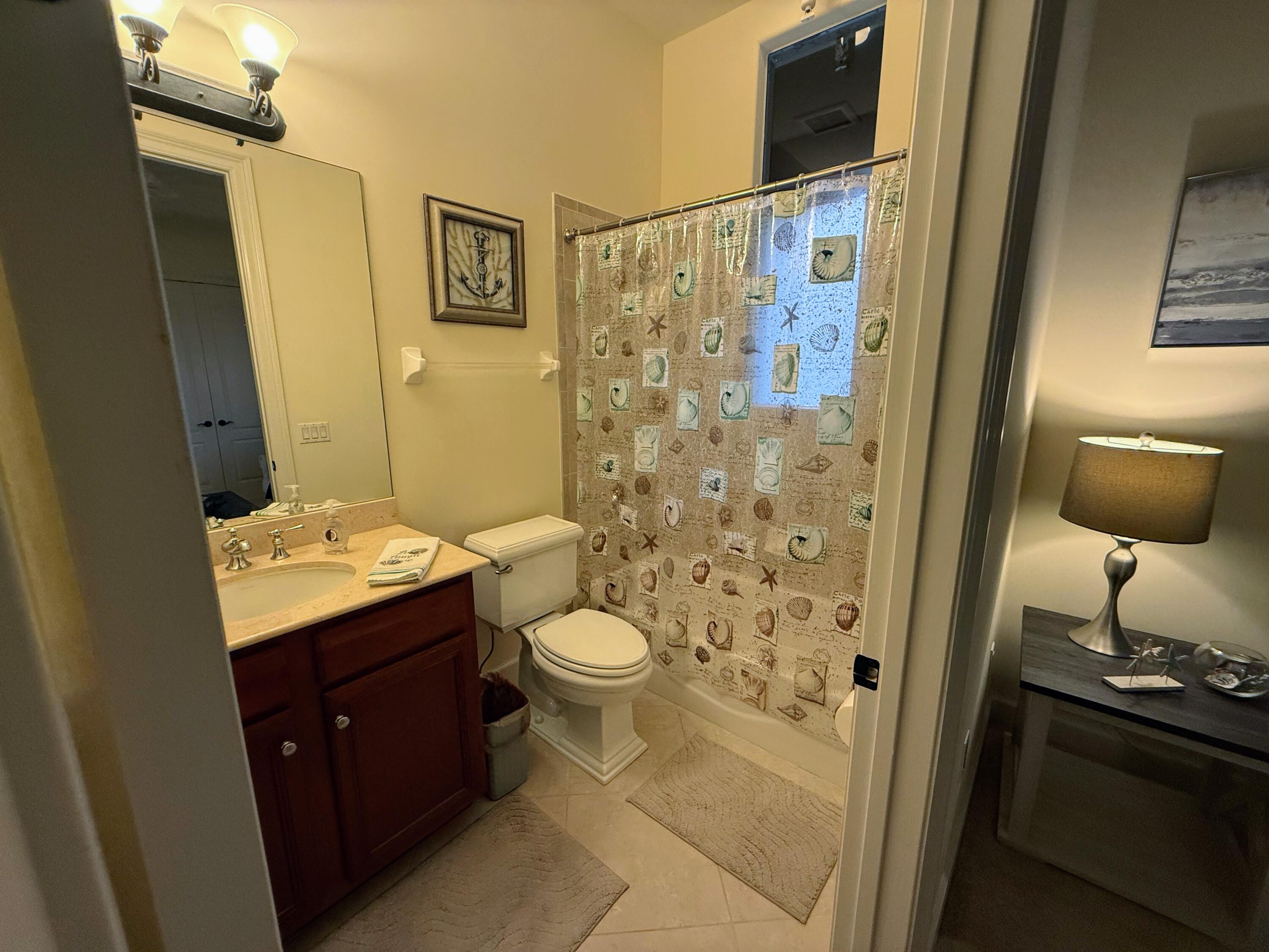 20 Orange Avenue, Unit 9 Fort Pierce, FL 34950 - Photo 48 of 92 a bathroom with a granite countertop sink toilet and shower