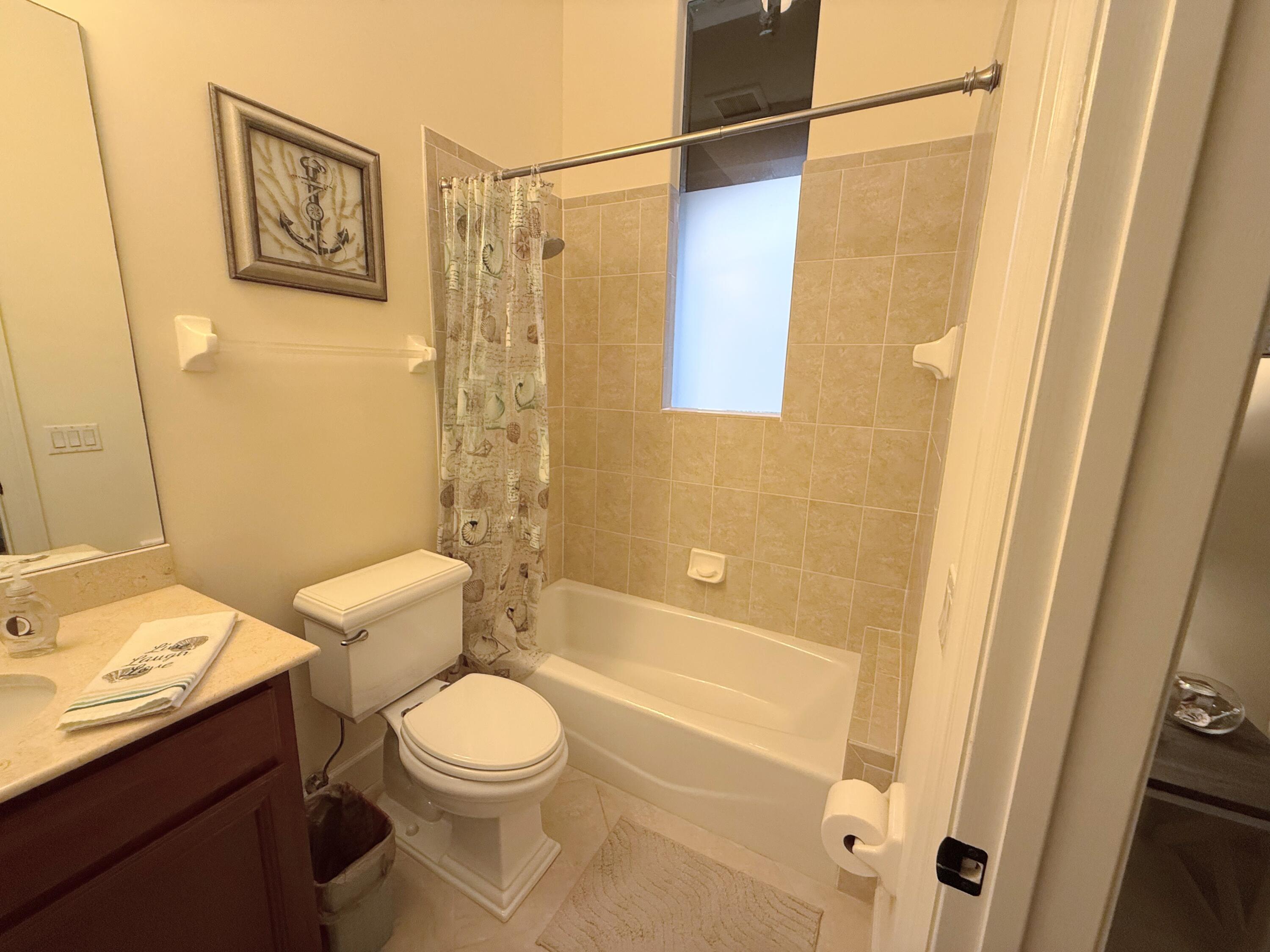 20 Orange Avenue, Unit 9 Fort Pierce, FL 34950 - Photo 49 of 92 a bathroom with a toilet a sink and a shower