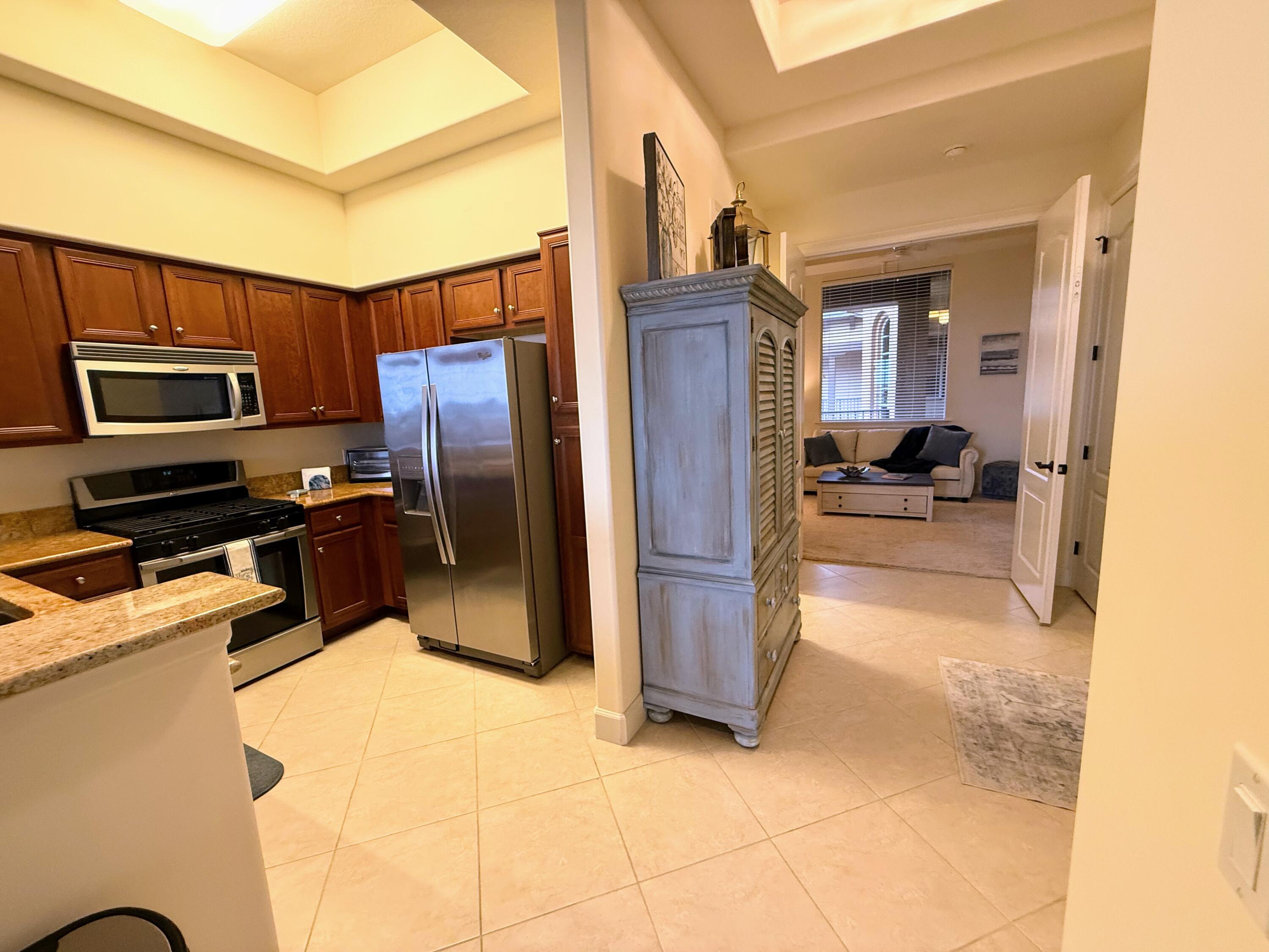 20 Orange Avenue, Unit 9 Fort Pierce, FL 34950 - Photo 52 of 92 a kitchen with a refrigerator and a stove