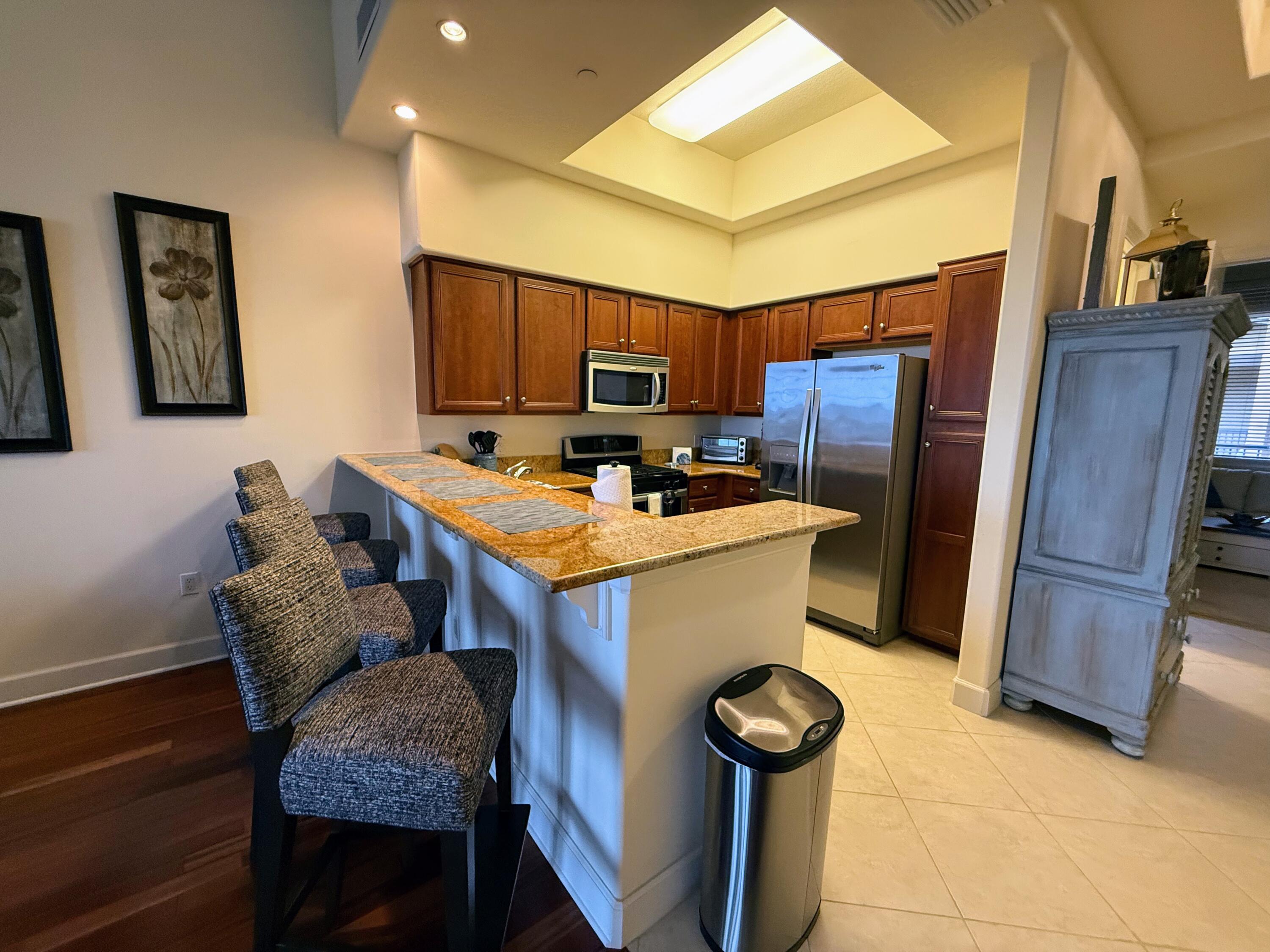 20 Orange Avenue, Unit 9 Fort Pierce, FL 34950 - Photo 56 of 92 a kitchen with stainless steel appliances granite countertop a stove refrigerator and a refrigerator