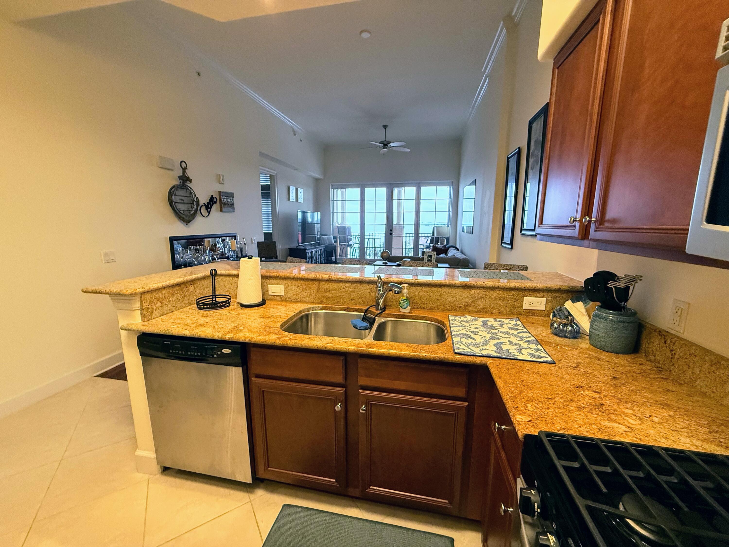 20 Orange Avenue, Unit 9 Fort Pierce, FL 34950 - Photo 58 of 92 a kitchen with a sink a stove and cabinets