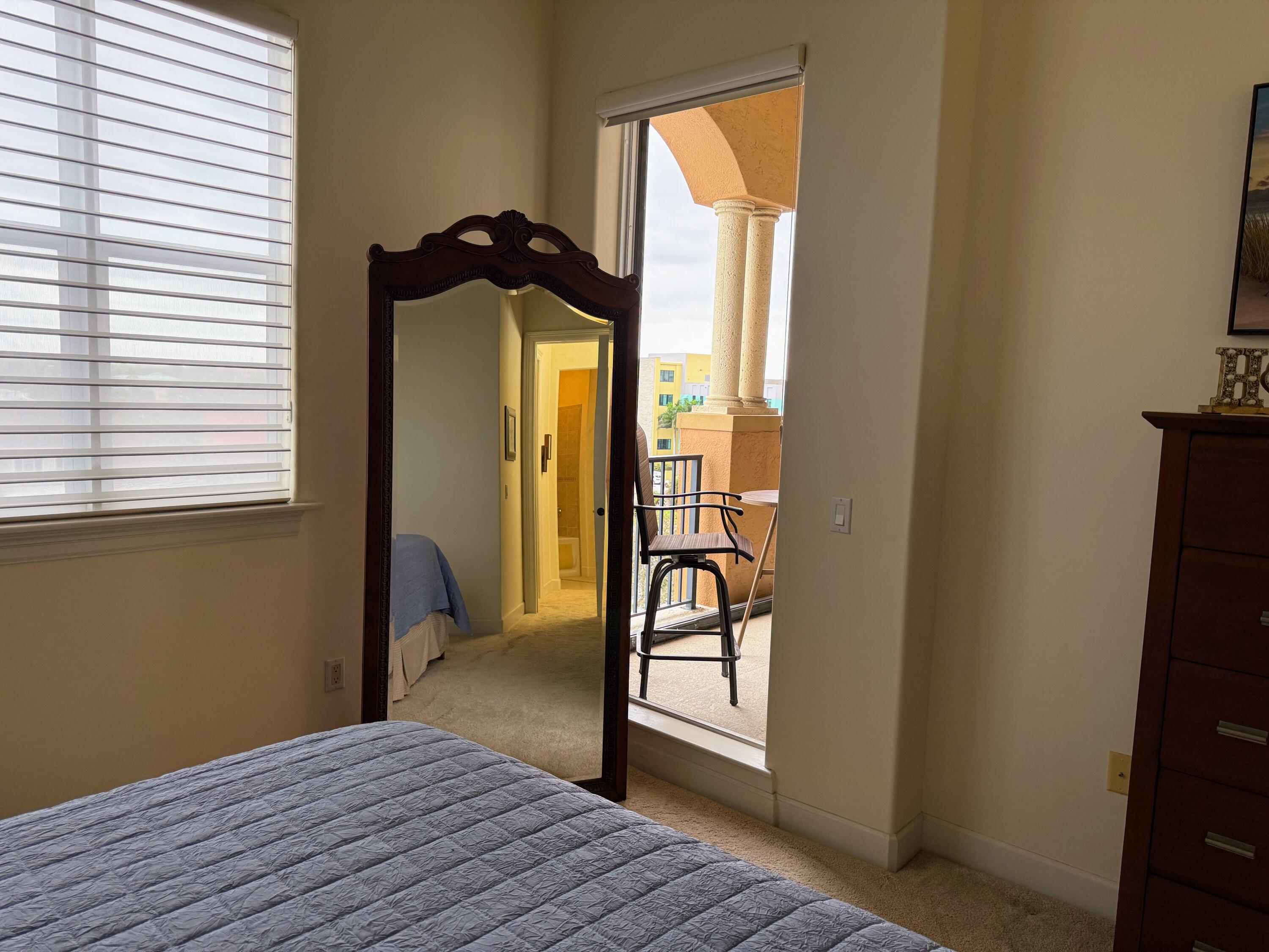 20 Orange Avenue, Unit 9 Fort Pierce, FL 34950 - Photo 68 of 92 a bedroom with a bed and a window