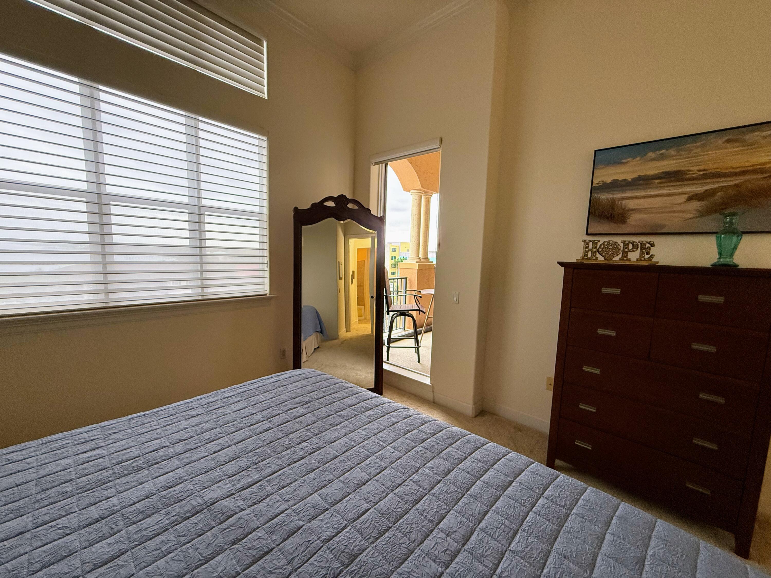 20 Orange Avenue, Unit 9 Fort Pierce, FL 34950 - Photo 71 of 92 a bedroom with a bed and a dresser