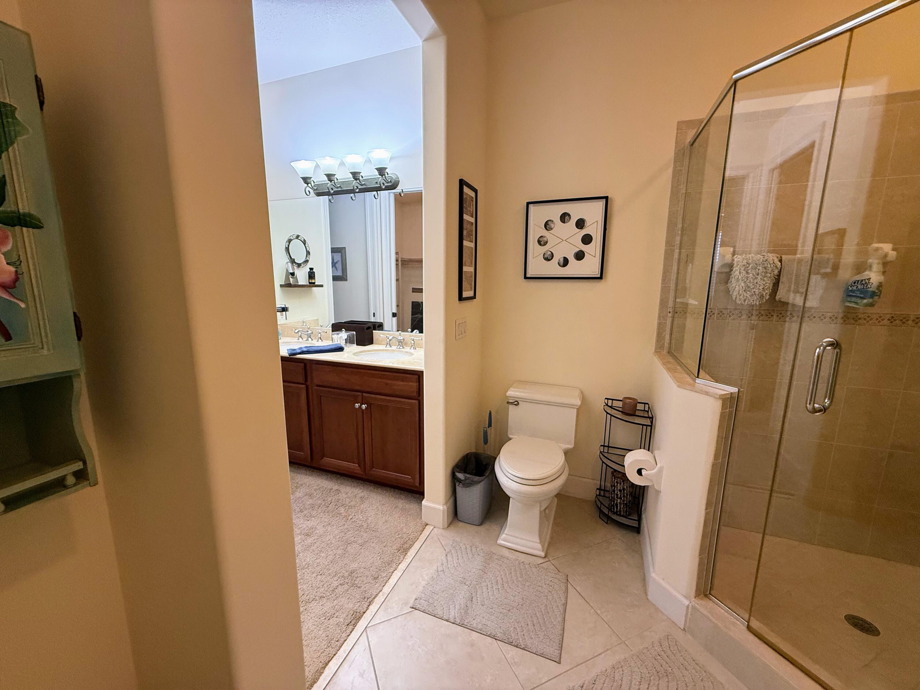 20 Orange Avenue, Unit 9 Fort Pierce, FL 34950 - Photo 80 of 92 a bathroom with a granite countertop sink toilet and shower