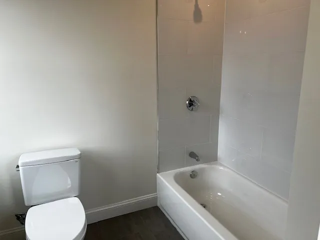 a bathroom with a toilet and bathtub