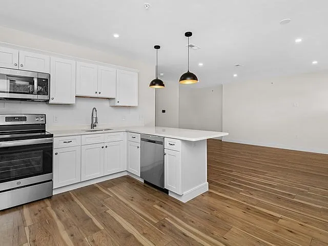 a kitchen with a sink stainless steel appliances and cabinets