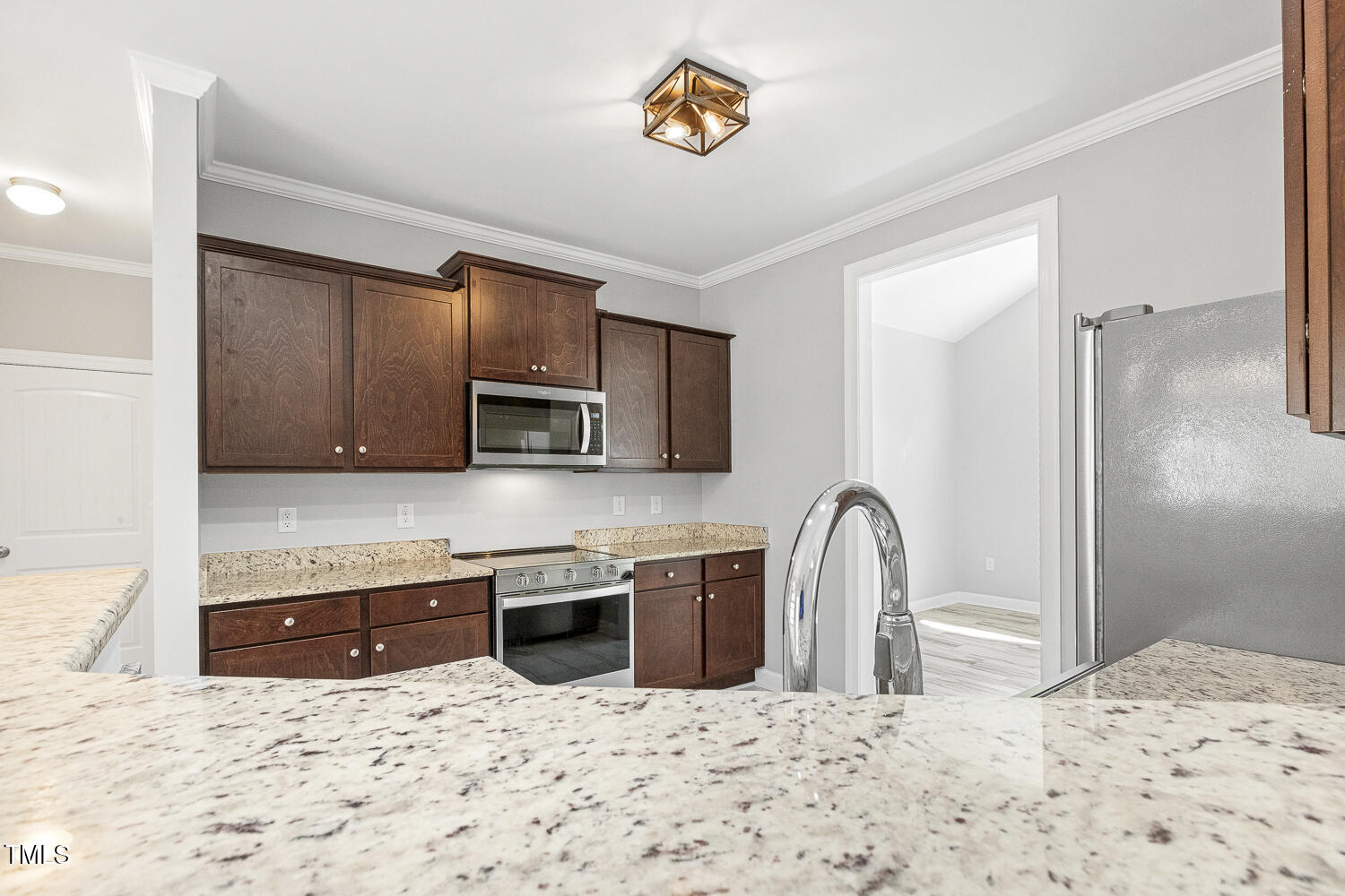 808 Cross Link Drive Angier, NC 27501 - Photo 10 of 30 a kitchen with stainless steel appliances kitchen island granite countertop a refrigerator a stove a sink and a microwave