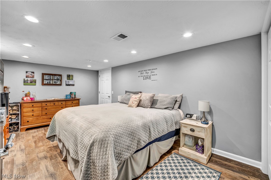 977 Lloyd Road Wickliffe, OH 44092 - Photo 24 of 38 In-law/guest suite bedroom with recessed ceiling lighting, durable wood-finish flooring, light gray wall paint and egress window.
