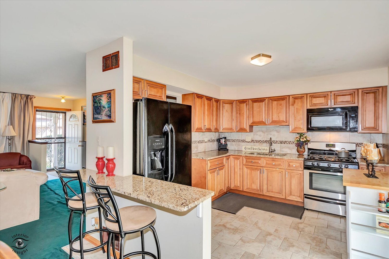 3257 Magnolia Drive Markham, IL 60428 - Photo 9 of 26 a kitchen with stainless steel appliances kitchen island granite countertop a refrigerator and a stove top oven