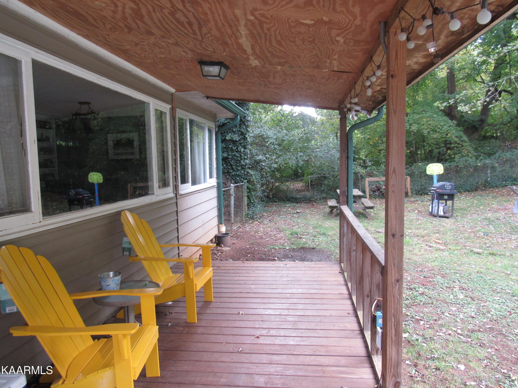 146 Outer Drive Oak Ridge, TN 37830 - Photo 30 of 38 a view of a patio with table and chairs with wooden floor and fence