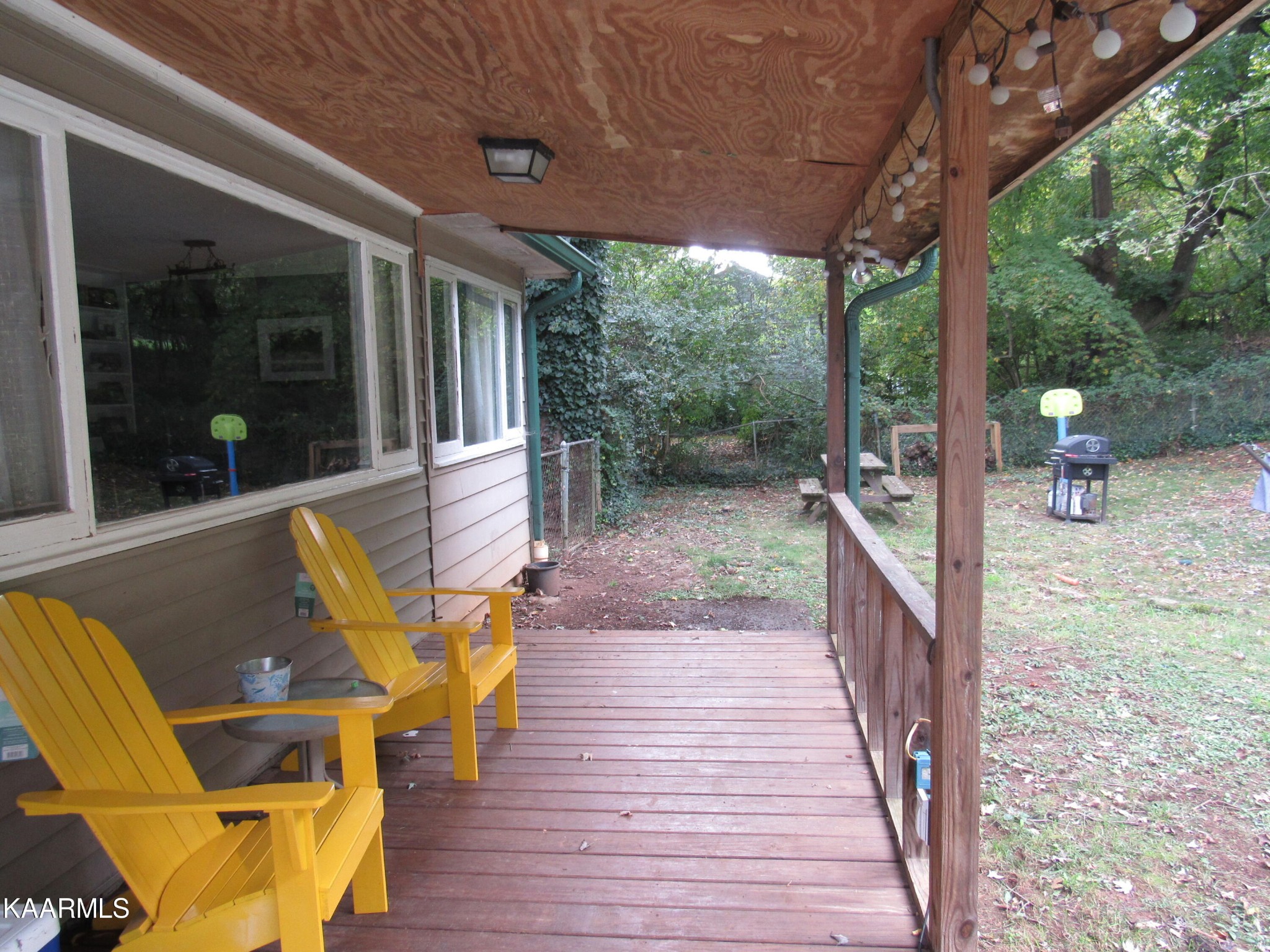 146 Outer Drive Oak Ridge, TN 37830 - Photo 31 of 38 a view of a patio with table and chairs next to a yard