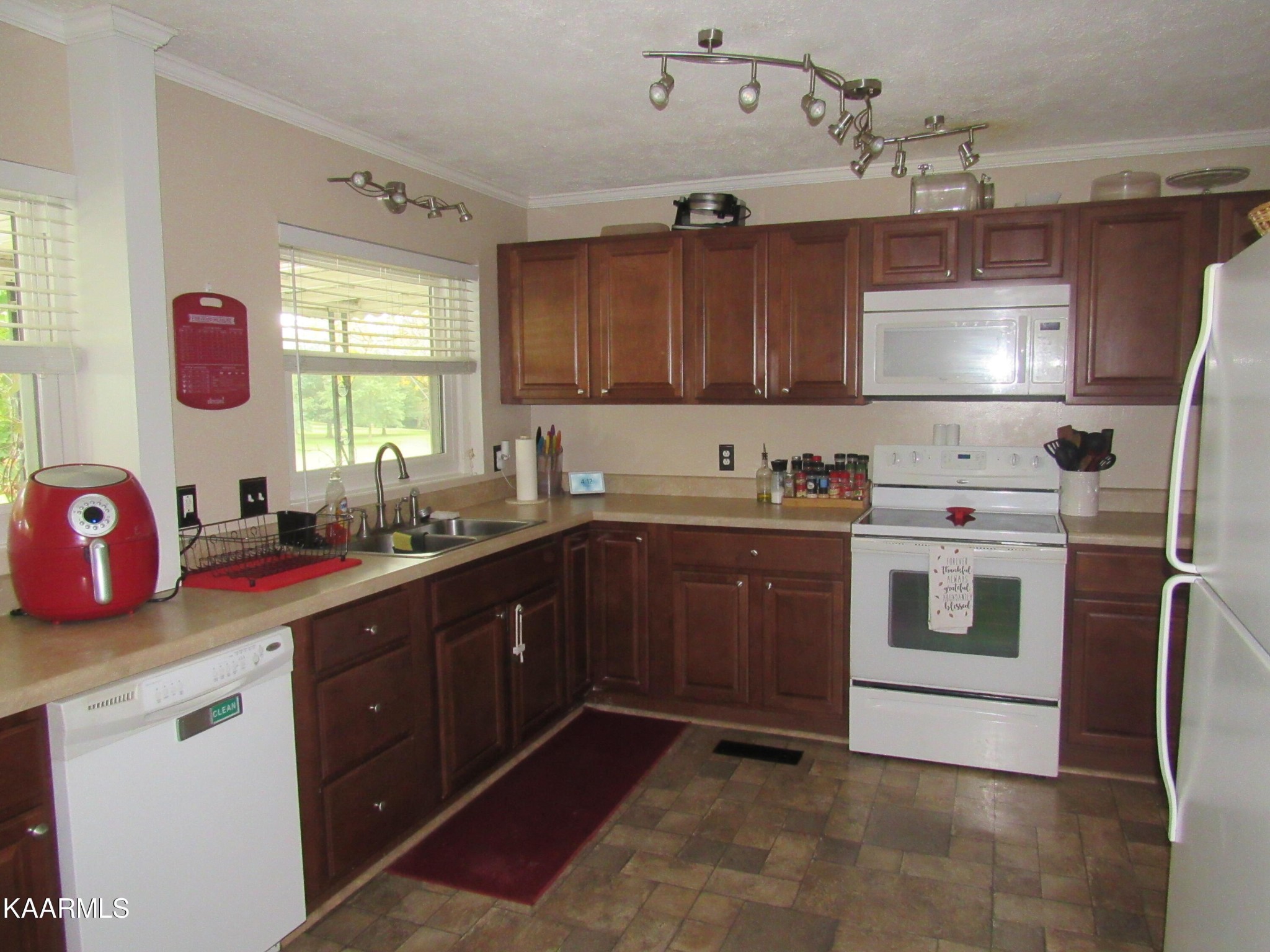 146 Outer Drive Oak Ridge, TN 37830 - Photo 9 of 38 a kitchen with a stove a sink a window and cabinets