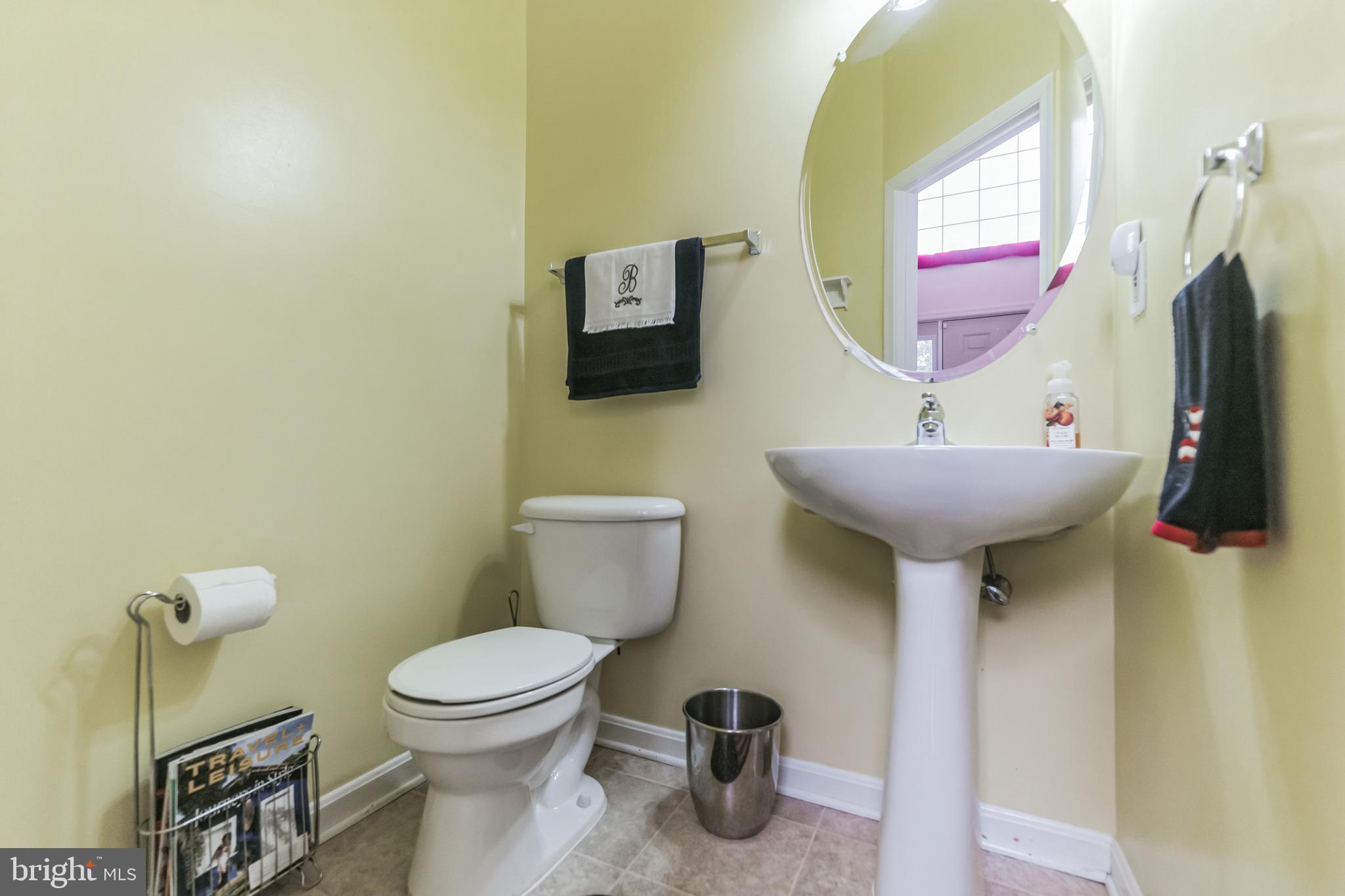 9879 Upper Mill Loop Bristow, VA 20136 - Photo 15 of 32 Main level half bath w/ pedestal sink