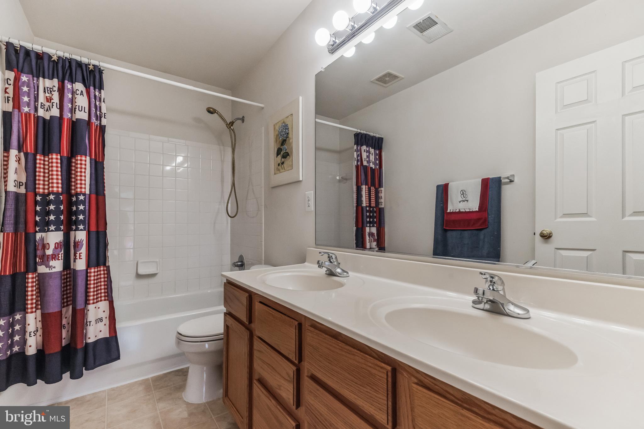 9879 Upper Mill Loop Bristow, VA 20136 - Photo 19 of 32 Upper full bath w/ dbl sink, cer. tile tub/shower