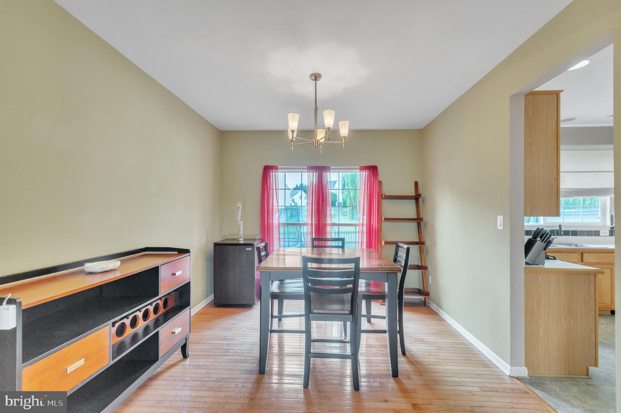 9879 Upper Mill Loop Bristow, VA 20136 - Photo 8 of 32 12x11 Dining room w/ hardwood & chandelier