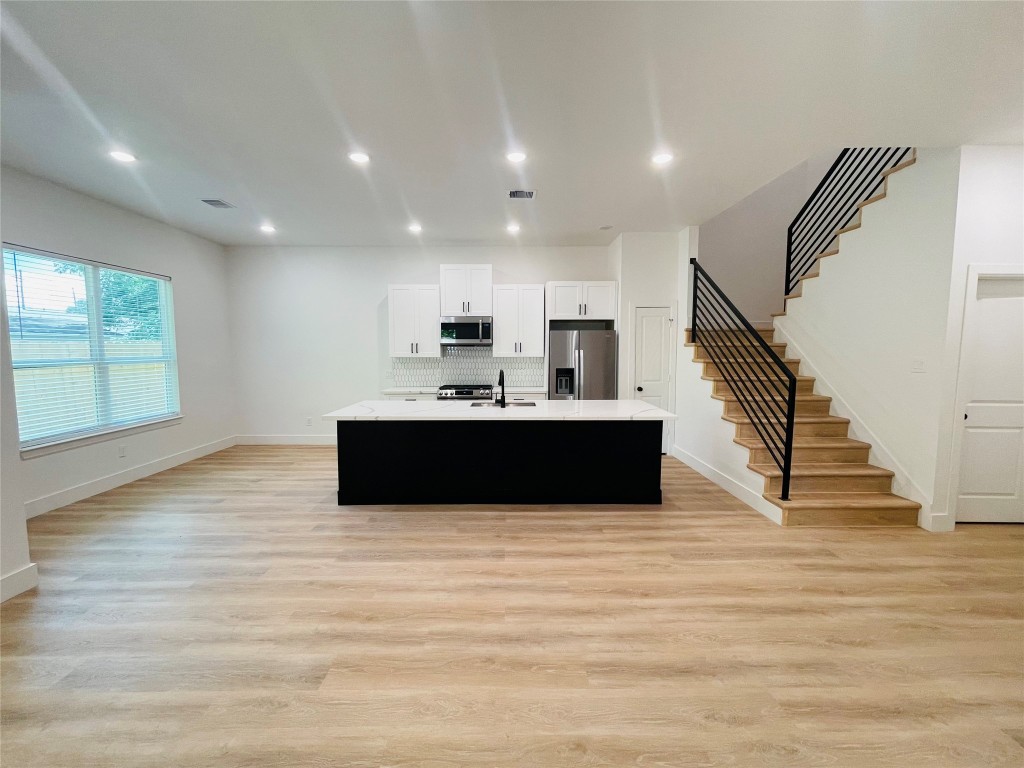 5312 Denmark Street Houston, TX 77028 - Photo 2 of 16 a view of an empty room with wooden floor and stairs