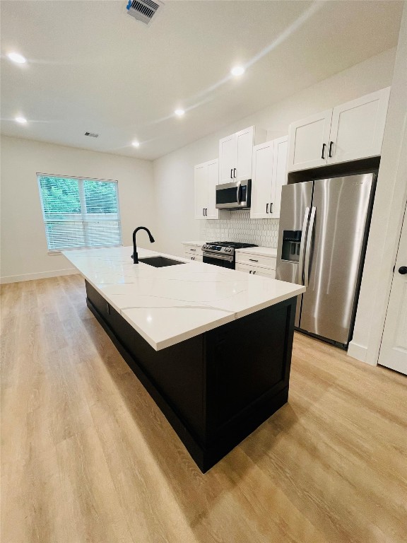 5312 Denmark Street Houston, TX 77028 - Photo 3 of 16 a kitchen with kitchen island wooden cabinets a refrigerator sink and stove