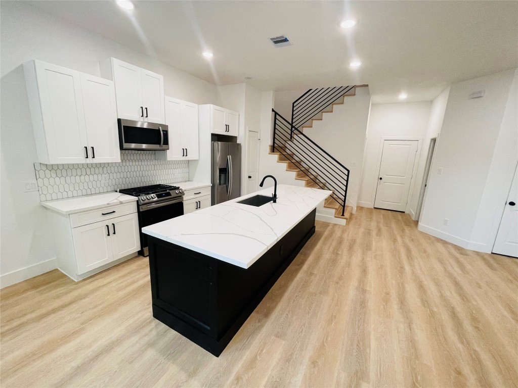 5312 Denmark Street Houston, TX 77028 - Photo 4 of 16 a kitchen with a sink appliances and cabinets