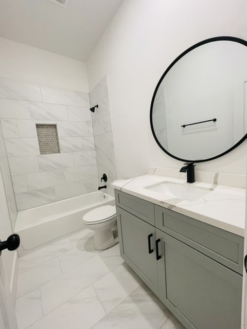 5312 Denmark Street Houston, TX 77028 - Photo 10 of 16 a bathroom with a granite countertop toilet a sink and a mirror