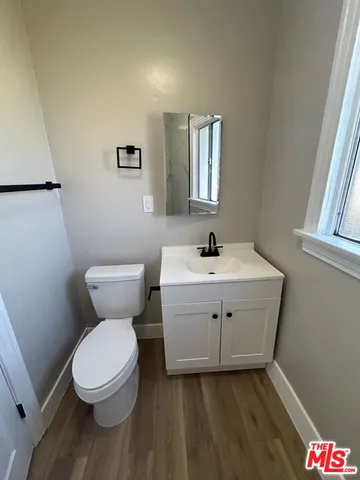 a white toilet sitting next to a bathroom sink
