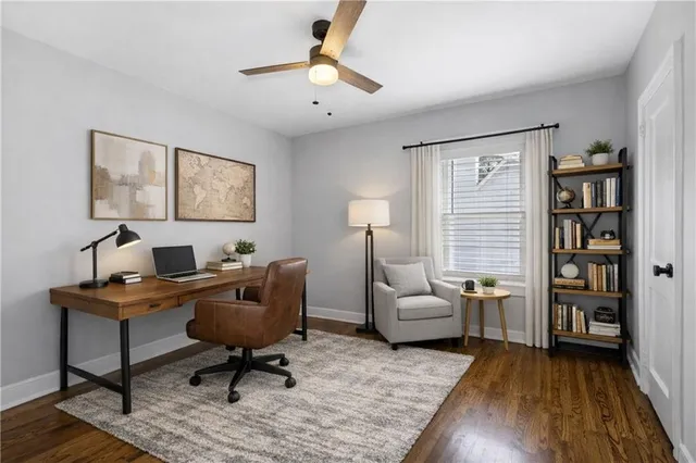 a view of a livingroom with workspace and a window