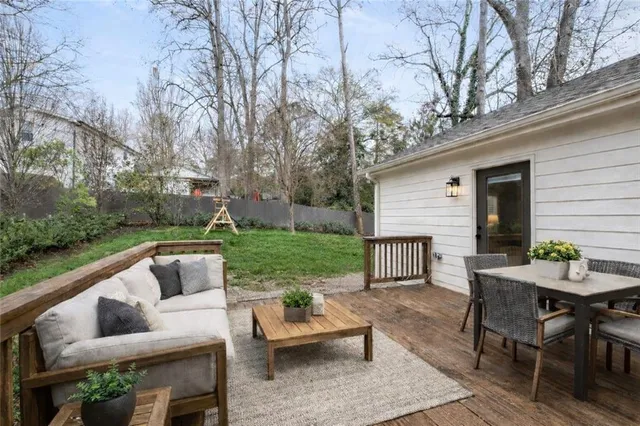a view of house with outdoor seating and green space