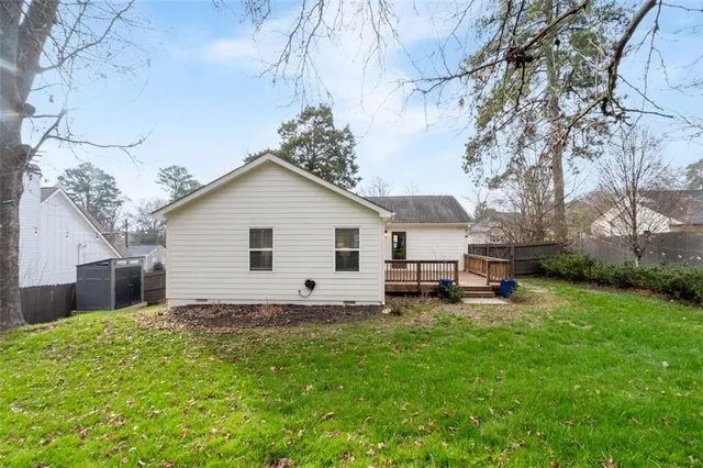 a view of a house with a yard and sitting area