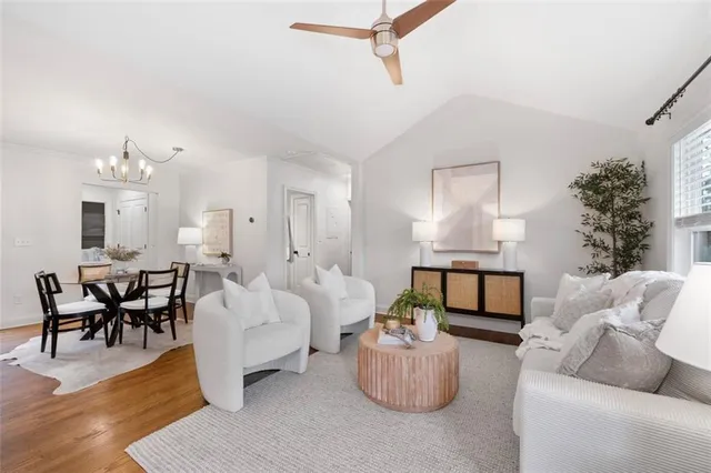 a living room with furniture and a chandelier