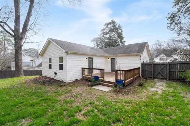 a view of a house with backyard and trees