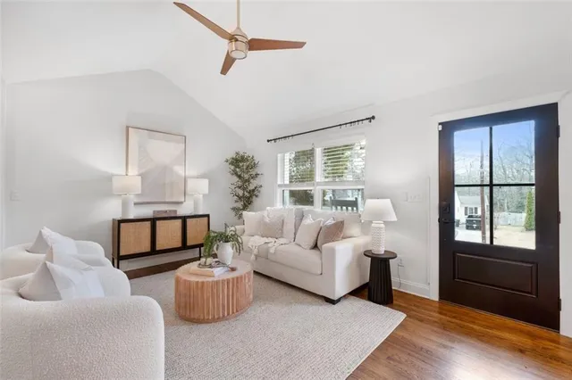 a living room with furniture and wooden floor