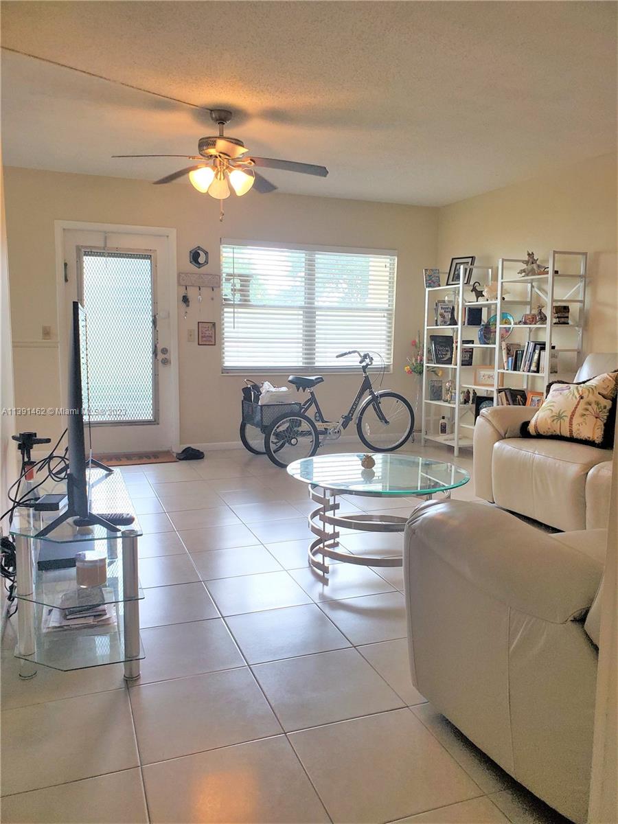 550 Mansfield M, Unit 550 Boca Raton, FL 33434 - Photo 1 of 14 a living room with furniture and a large window